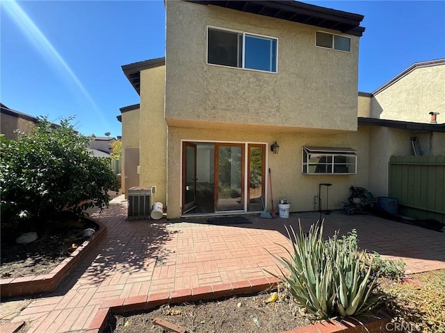 rear view of property with central AC and a patio