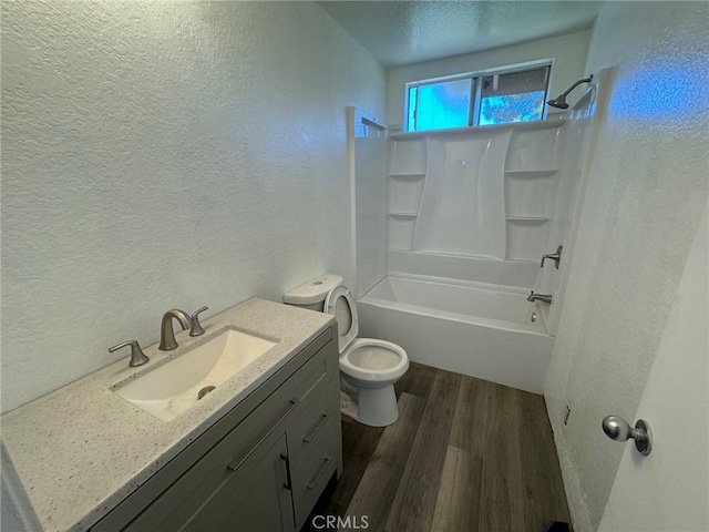 full bathroom with toilet, vanity, bathtub / shower combination, and hardwood / wood-style flooring