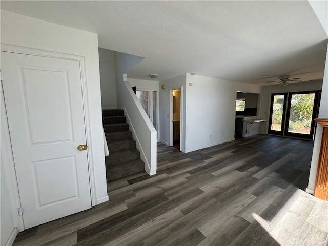 interior space featuring ceiling fan and dark wood-type flooring