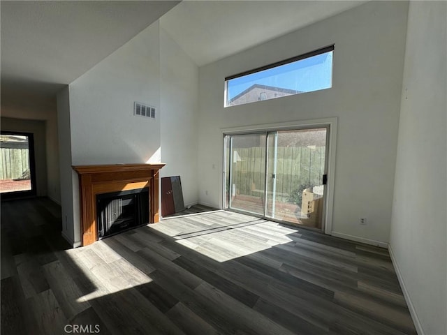 living room featuring high vaulted ceiling and dark wood-type flooring