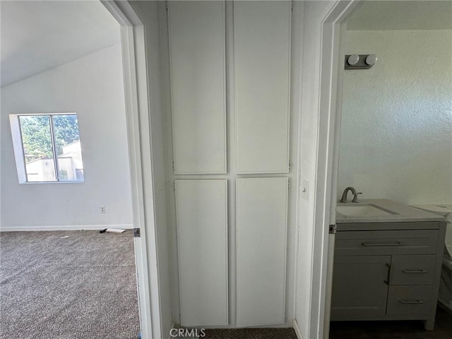 bathroom featuring vaulted ceiling and vanity