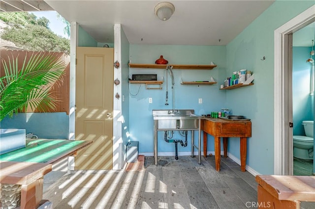 kitchen with wood finished floors and baseboards