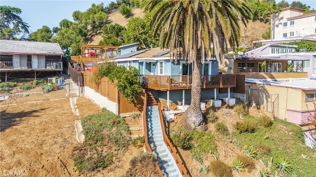 back of house with a wooden deck