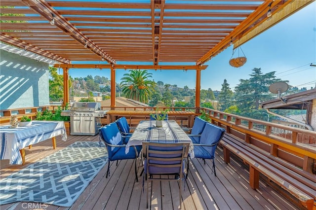 deck with a grill, a pergola, and outdoor dining space