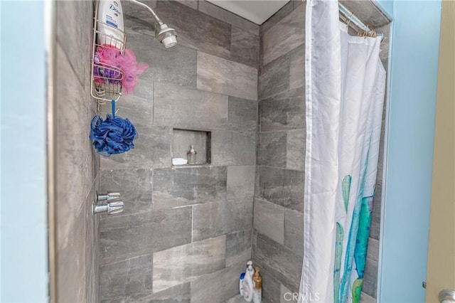 bathroom with a tile shower