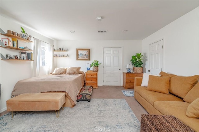 carpeted bedroom featuring visible vents