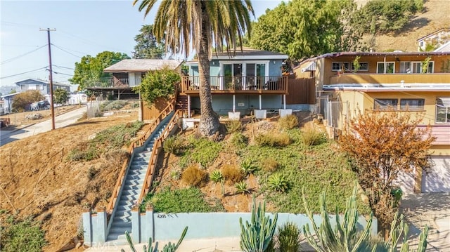 view of front of house featuring fence and stairs