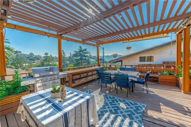 wooden deck featuring a pergola, area for grilling, and outdoor dining space