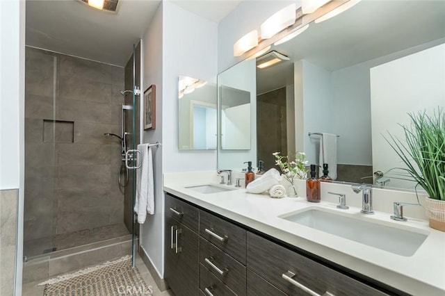 bathroom with vanity and tiled shower