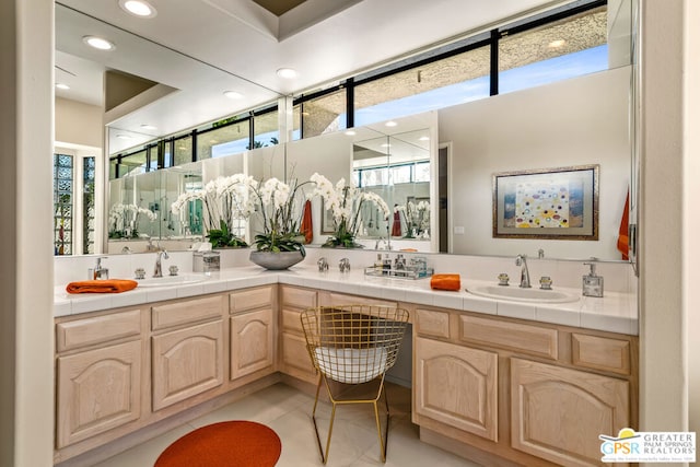 bathroom featuring vanity, tile patterned flooring, and a healthy amount of sunlight