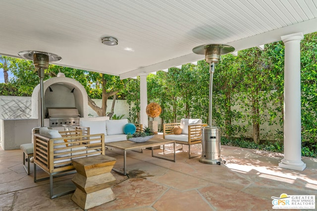 view of patio / terrace with an outdoor kitchen, an outdoor living space, and a grill