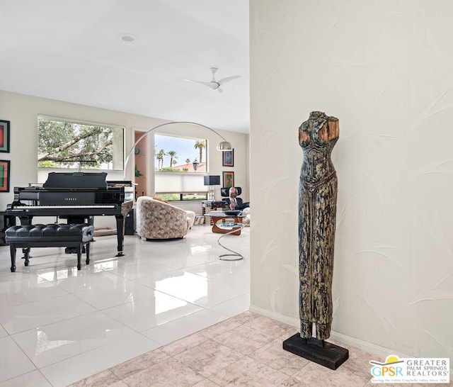 interior space featuring light tile patterned flooring and ceiling fan