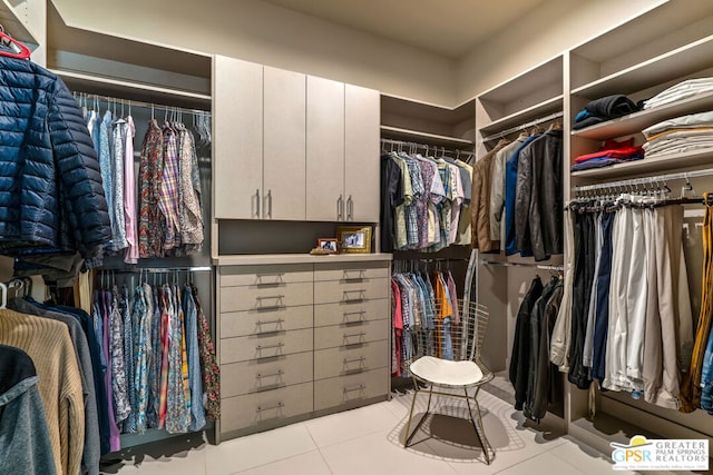 spacious closet with light tile patterned floors