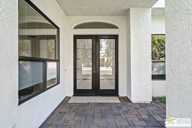 view of exterior entry featuring french doors