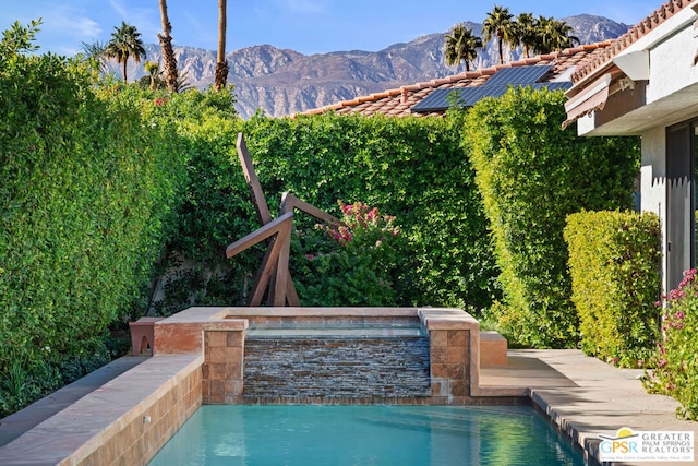 view of swimming pool with a mountain view