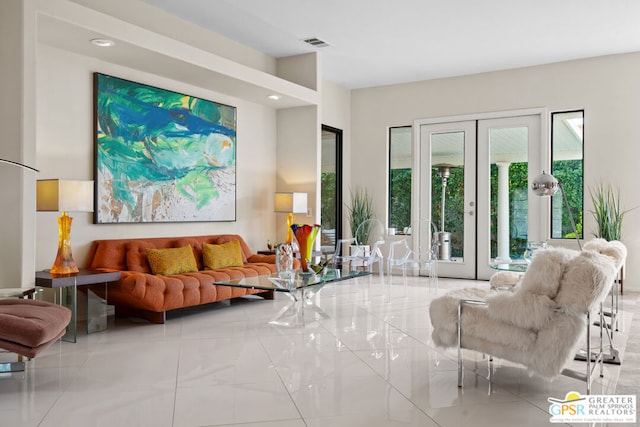 living room featuring light tile patterned floors and french doors