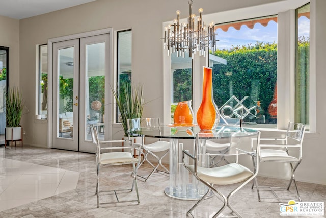 dining space featuring an inviting chandelier, plenty of natural light, and french doors