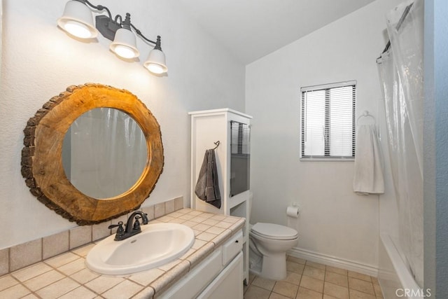 bathroom featuring tile patterned floors, vanity, toilet, and vaulted ceiling