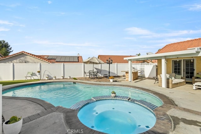 view of pool featuring a patio area and an in ground hot tub