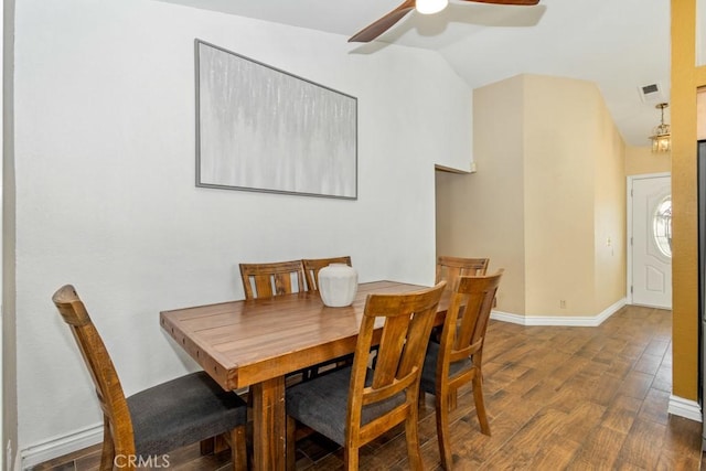 dining room featuring ceiling fan, dark hardwood / wood-style floors, and vaulted ceiling