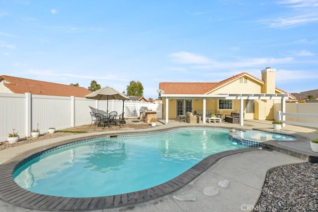 view of swimming pool with an outdoor hangout area, a patio area, and an in ground hot tub