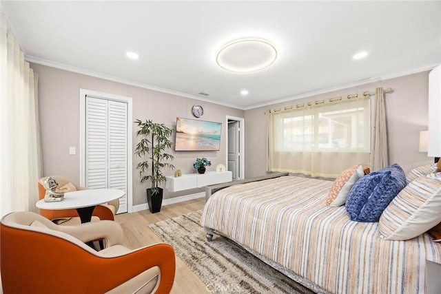 bedroom with ornamental molding and light hardwood / wood-style floors