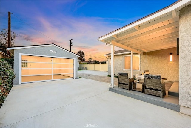 view of garage at dusk