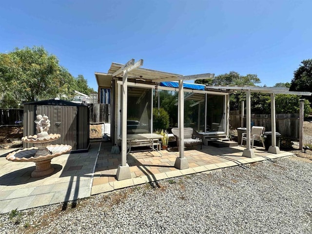 back of house featuring a shed and a patio