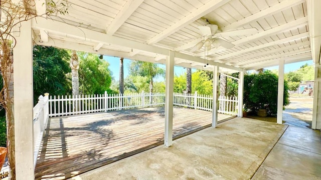 unfurnished sunroom with ceiling fan