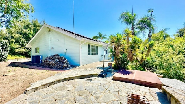 rear view of house with a patio area and central air condition unit