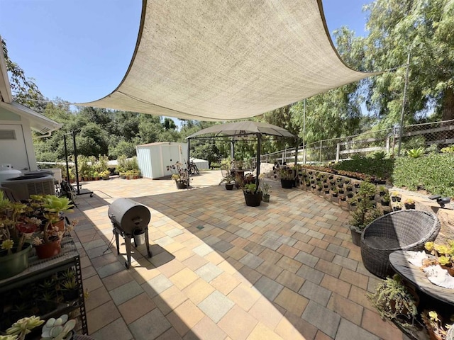 view of patio with central AC and a storage unit