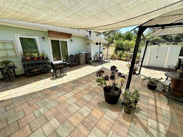 view of patio with area for grilling and a shed