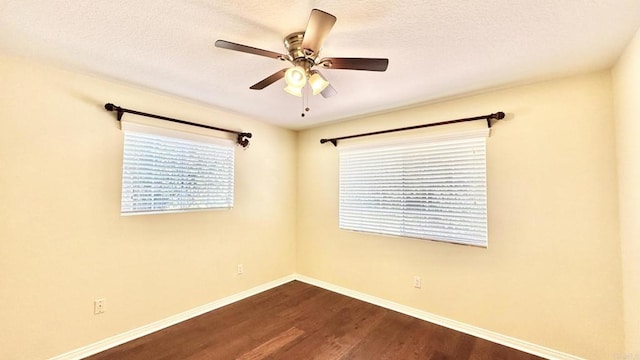 empty room with ceiling fan, hardwood / wood-style floors, and a textured ceiling