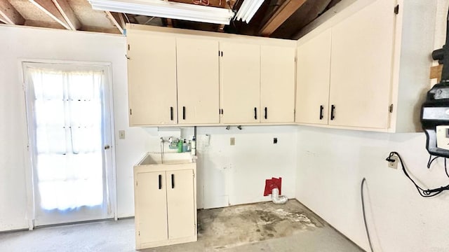 laundry room featuring sink and cabinets