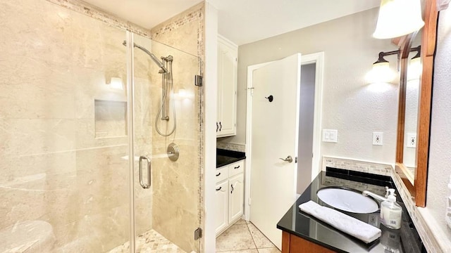 bathroom featuring vanity, tile patterned floors, and walk in shower