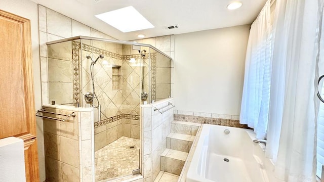 bathroom with separate shower and tub and a skylight