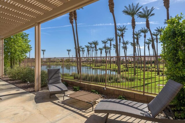 view of patio featuring a water view and a pergola