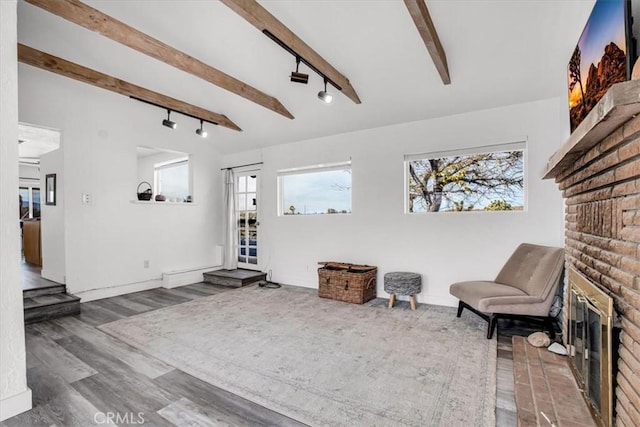 59427 La Crescenta Dr, Yucca Valley, CA 92284 - sitting room with lofted ceiling with beams, track lighting, wood finished floors, and a healthy amount of sunlight