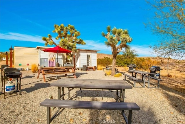 view of community featuring a storage unit and a patio