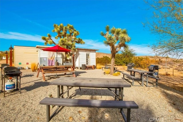 59427 La Crescenta Dr, Yucca Valley, CA 92284 - view of community featuring an outbuilding and a patio