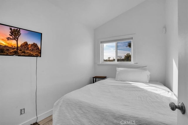 59427 La Crescenta Dr, Yucca Valley, CA 92284 - bedroom with baseboards, vaulted ceiling, and wood finished floors
