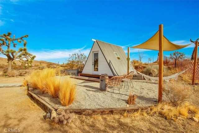 59427 La Crescenta Dr, Yucca Valley, CA 92284 - view of playground featuring a storage shed, an outbuilding, and fence