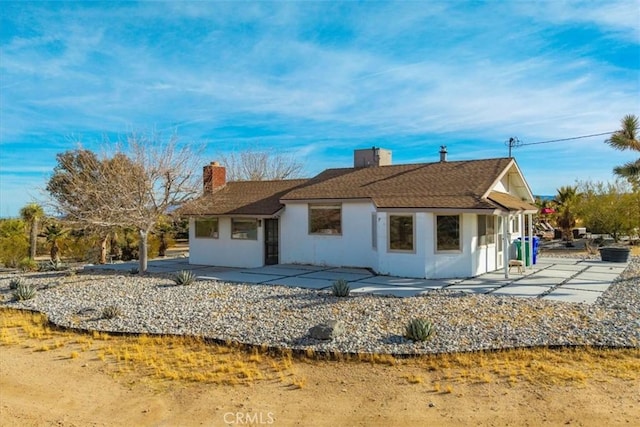 59427 La Crescenta Dr, Yucca Valley, CA 92284 - exterior space featuring a patio area, stucco siding, and a chimney