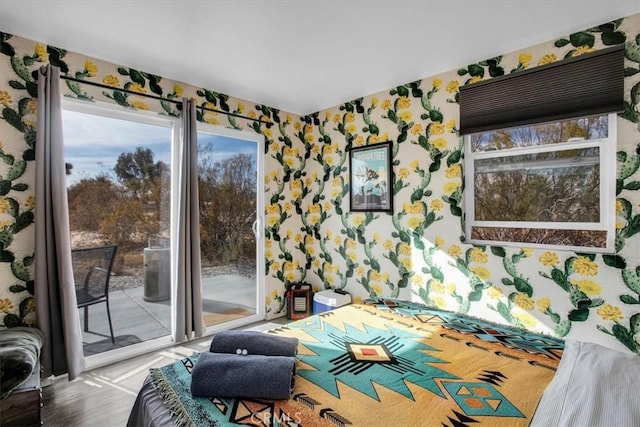 59427 La Crescenta Dr, Yucca Valley, CA 92284 - bedroom featuring access to exterior, wallpapered walls, and wood finished floors