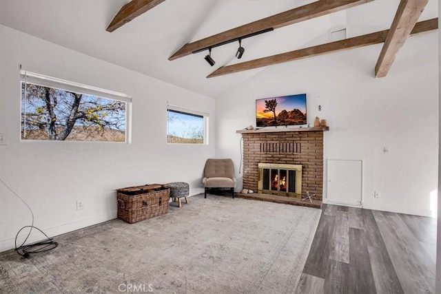 59427 La Crescenta Dr, Yucca Valley, CA 92284 - living area featuring baseboards, a brick fireplace, beam ceiling, wood finished floors, and high vaulted ceiling
