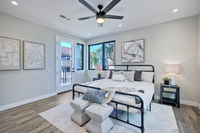 bedroom with ceiling fan, light wood-type flooring, and access to exterior