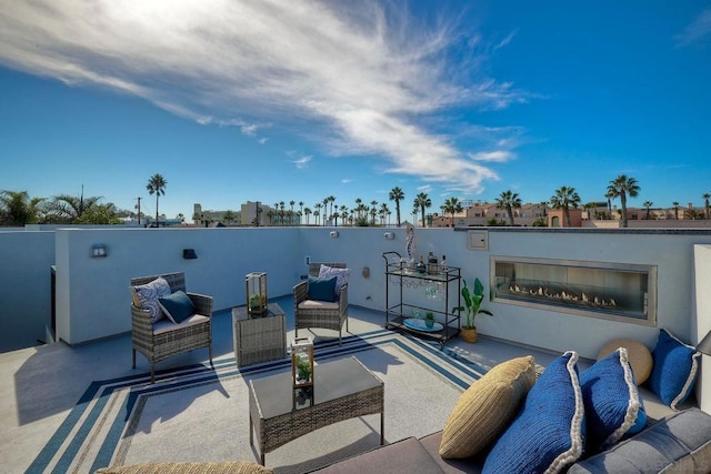 view of patio featuring an outdoor living space with a fireplace