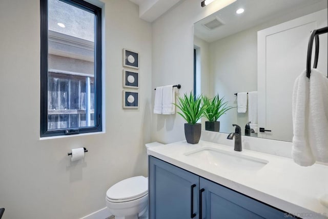 bathroom featuring toilet and vanity