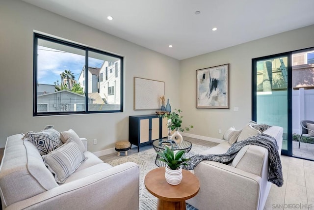 living room featuring a wealth of natural light and light wood-type flooring