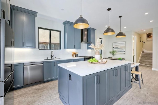 kitchen featuring pendant lighting, dishwasher, a center island, sink, and light hardwood / wood-style flooring